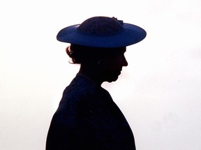 Queen Elizabeth II is silhouetted in Barbados in 1989 during welcoming ceremonies at the airport. A new poll suggests most Canadians feel no attachment to the British monarchy, and that few have been personally impacted by Queen Elizabeth's death.