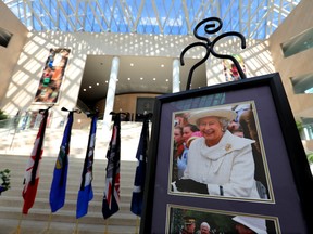 Photos and a book of condolence for Queen Elizabeth II have been set up at Edmonton City Hall, Friday, Sept. 9, 2022.