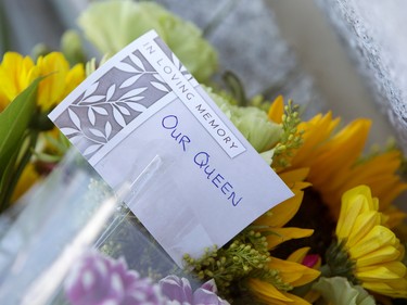 Flowers for Queen Elizabeth II lay on the steps outside the Alberta Legislature in Edmonton, Friday, Sept. 9, 2022. A book of condolence for the Queen has been set up inside the Alberta Legislature rotunda.