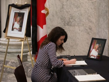 Edmontonians sign a book of condolence for Queen Elizabeth II at the Alberta Legislature in Edmonton, Friday, Sept. 9, 2022.