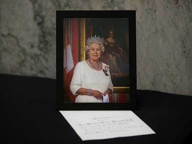 A portrait of Queen Elizabeth II and a message of condolence from the Lieutenant Governor of Alberta Salma Lakhani, inside the Alberta Legislature rotunda in Edmonton, Friday, Sept. 9, 2022.