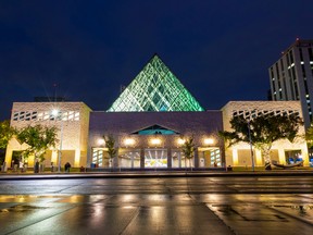 Wet streets reflect the lights from City Hall on Monday, Sept. 19, 2022, in Edmonton.