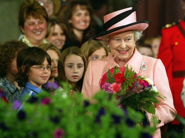Queen Elizabeth II enters the foyer of the Alberta Legislature surrounded by school children and the public on Tuesday, May 24, 2005.