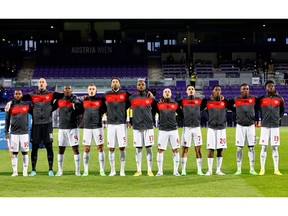 Canada players line up during the national anthems before the match against Qatar on Sept. 23, 2022.