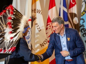 Frog Lake First Nation Chief Greg Desjarlais shakes hands with Enbridge president and CEO Al Monaco after an agreement on the largest Indigenous energy investment in North America is announced between Enbridge and 23 First Nations and Metis communities on Wednesday.