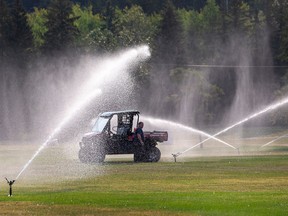 City staff activated the water sprinklers at Hawrelak Park on Saturday September 3, 2022 in Edmonton. With temperatures expected to reach 34°C, the grass is watered early in the morning. Greg Southam - Postmedia