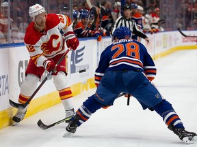 Trevor Lewis #22 of the Calgary Flames skates against Ryan Murray #28 of the Edmonton Oilers during the first period at Rogers Place on October 15, 2022 in Edmonton, Canada.