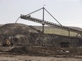 A hopper moves dirt in Suncor's Millennium mine in the oilsands in Fort McMurray Alta, on Monday June 13, 2017. Canada's biggest oilsands producers say they will spend $16.5 billion before 2030 on the first stage of a massive proposed carbon capture and storage facility near Cold Lake, Alta.