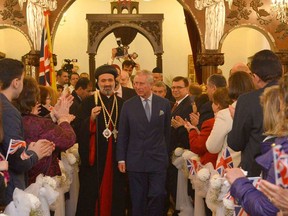 Then-prince Charles, centre right, visits a Syriac (Syrian) Orthodox Church in west London in 2013.