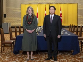 Canadian Foreign Minister Melanie Joly and Japanese Foreign Minister Yoshimasa Hayashi pose for media prior to their meeting at the Iikura Guest House in Tokyo, Tuesday, Oct. 11, 2022.