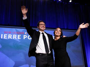 Pierre Poilievre, left, and his wife Anaida Poilievre take the stage after winning the Conservative party leadership election, in Ottawa on Sept. 10.