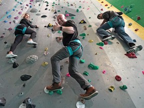 Leo Namen, middle, a heart attack survivor, and two members of his climbing team Kandace Halcrow, left, and Tyler Halcrow scale a climbing wall at the University of Alberta's Wilson Climbing Centre in Edmonton on Oct. 14, 2022. They are planning to climb Alaska's Mount Denali in May 2023 for charity. Proceeds will support Indigenous Sports Council Alberta.
