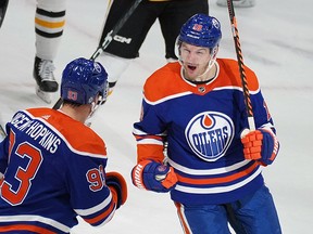 Edmonton Oilers Zach Hyman (right) celebrates a goal by teammate Ryan Nugent-Hopkins (left) during second period National Hockey League game action against the Pittsburgh Penguins in Edmonton on Monday, October 24, 2022.