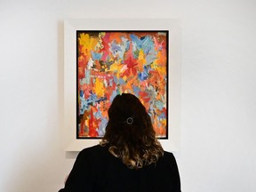 A woman views 'Small False Start' by Jasper Johns on display at Christie's Los Angeles on October 12, 2022, during a preview of "Visionary: The Paul Allen Collection" - a $1 billion art auction, the most expensive collection ever to go under the hammer.