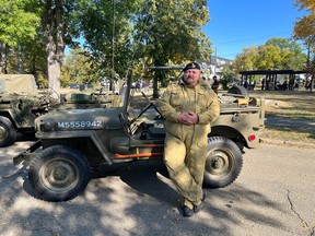 Retired sergeant Robert McCue of the South Alberta Light Horse regiment poses in front of a restored Jeep from the Second World War. McCue served in Afghanistan in 2006 and helped his former interpreter and his family escape Afghanistan after the Taliban took over last year.