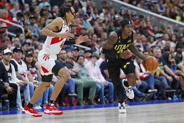 Utah Jazz forward Rudy Guy (8) carries the ball up court with Toronto Raptors forward Dalano Banton (45) during the third quarter at Rogers Place.