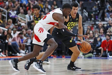Toronto Raptors center Khem Birch (24) carries the ball around Utah Jazz forward Simone Fontecchio (16) during the fourth quarter at Rogers Place.