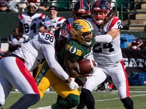 Edmonton Elks running back Kevin Brown (4) is tackled by Montreal Alouettes defensive lineman Michael Wakefield (96) at Commonwealth stadium in Edmonton on Saturday, Oct. 1, 2022.