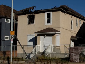 A boarded-up and fire-damaged home along 95 Street near 110 Avenue in Edmonton, Friday Oct. 28, 2022.