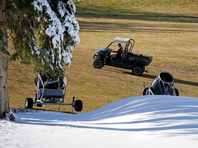 A gardener watches the slope at the Snow Valley Ski Club in Edmonton Wednesday, Oct. 26, 2022, where snowmaking has already begun.  The weather forecast for the next four days calls for sunshine with temperatures reaching a high of 15 degrees Celsius.