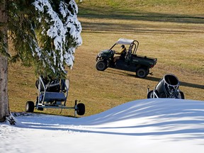 A gardener watches the slope at the Snow Valley Ski Club in Edmonton Wednesday, Oct. 26, 2022, where snowmaking has already begun. The weather forecast for the next four days calls for sunshine with temperatures reaching a high of 15 degrees Celsius.