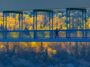 Walkers make their way across the Dudley B. Menzies Bridge on Thursday, Oct. 6, 2022, in Edmonton.
