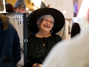 Dressed as a witch Jeweller Celine Gibson takes part in the Halloween themed Hazeldean Community Artisan Market, 9630 66 Ave., in Edmonton, Saturday, Oct. 29, 2022.