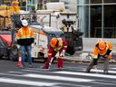 Construction crews work on a pedestrian crossing at 101 Street and 103 Avenue in downtown Edmonton, Tuesday, Oct. 25, 2022.