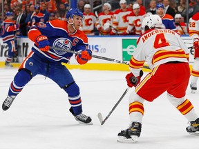 Calgary Flames defensemen Rasmus Andersson (4) tries to block a shot by Edmonton Oilers forward Connor McDavid (97) during the third period at Rogers Place on Oct. 15, 2022.