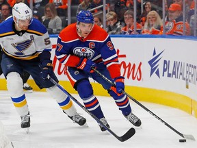 Oct 22, 2022; Edmonton, Alberta, CAN; Edmonton Oilers/ forward Connor McDavid (97) moves the puck from St. Louis Blues defensemen Colton Parayko (55) during the third period at Rogers Place. Mandatory Credit: Perry Nelson-USA TODAY Sports