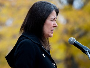 Alberta Premier Danielle Smith speaks to the media outside Government House following the swearing-in of her new cabinet ministers, in Edmonton Monday, Oct. 24, 2022.