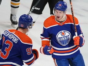 Edmonton Oilers Zach Hyman right celebrates a goal by teammate Ryan Nugent-Hopkins, left, during second period National Hockey League game action against the Pittsburgh Penguins in Edmonton on Monday, Oct. 24, 2022.