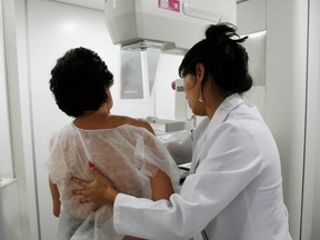 A woman undergoes a free mammogram inside Peru's first mobile unit for breast cancer detection, in Lima March 8, 2012. International Women's Day falls on March 8. REUTERS/Enrique Castro-Mendivil (PERU - Tags: HEALTH) ORG XMIT: LIM207