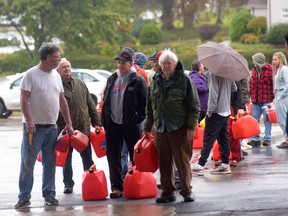 People line up with jerry cans to buy gasoline after post-tropical storm Fiona, in Charlottetown, Monday, Sept. 26, 2022. Generators are an increasing necessity and nuisance as Atlantic Canada experiences more frequent and severe storms with extended power outages.