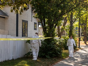 Police investigate the scene of a shooting at a house on the corner of 79 Avenue and 106 Street in Edmonton on Oct. 8, 2022.