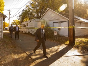 Police investigate the scene of a shooting at a house on the corner of 79 Ave and 106 St in Edmonton, October 8, 2022.