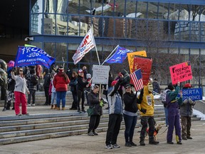 Around 150 people rallied against COVID-19 restrictions outside the Calgary Municipal Building on Jan. 6, 2021.