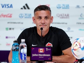 John Herdman, head coach of Canada, speaks during the Canada Press Conference at the Main Media Center on November 30, 2022 in Doha, Qatar.