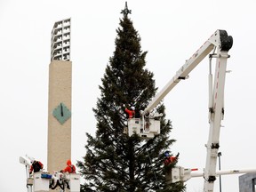 IN 2021, crews decorate Edmonton's giant Christmas tree in Churchill Square. The annual holiday light up festival will be moved this year.