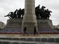 People walk past the National War Memorial before Remembrance Day ceremonies in Ottawa, Ontario, Canada, on Wednesday, Nov. 11, 2020.