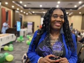 Andrea Bailey-Brown holds her 2022 AC Award recognizing women in business at the Four Points by Sheraton in south Edmonton on Saturday. The AC Awards recognize the achievements of Albertans with African ancestry, as well allies in the community.