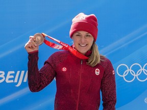 Christine De Bruin, of Canada, celebrates winning the bronze medal in the women's monobob at the 2022 Winter Olympics, Monday, Feb. 14, 2022, in the Yanqing district of Beijing.