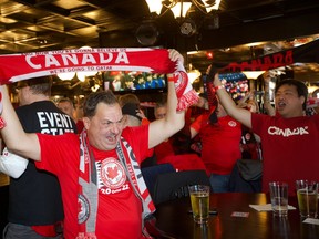 Football fans in The Pint on Whyte Avenue watch Team Canada head on to the field at the World Cup in Qatar on Wednesday, Nov. 23, 2022, for the first time 36 years.