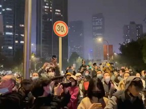 Protesters chant slogans in support of freedom of speech and the press, amid broader nationwide unrest due to COVID-19 lockdown policies, in Chengdu, China in this still image obtained from undated social media video released November 27, 2022. Video obtained by REUTERS