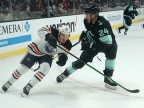 James Hamblin (left), a product of the Southside Athletic Club bantam AAA Lions, has made it to the NHL. Pictured here during the pre-season, Hamblin made his regular-season debut with the Oilers last night against the Panthers. Elaine Thompson/AP photo