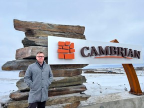 Senior Project Manager Scott Rudman stands beside the stunning entranceway of the new community of Cambrian being developed in Sherwood Park. It features Creston Valley stones and a dramatic Corten steel arch. SUPPLIED