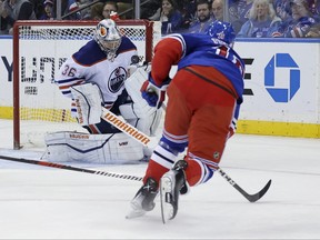 Oilers goaltender Jack Campbell makes a save against Rangers’ Vincent Trocheck on Saturday.