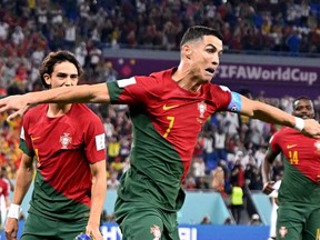 Portugal's forward #07 Cristiano Ronaldo (2nd L) celebrates scoring his team's first goal from a penalty shot during the Qatar 2022 World Cup Group H football match between Portugal and Ghana at Stadium 974 in Doha on November 24, 2022.