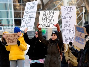 Members of the 4B Harm Reduction Society protest outside Edmonton city hall on Monday, Nov. 21, 2022, in response to what they say is city council's failure to provide a warm shelter for the city's unhoused.