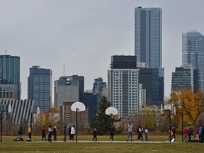 Students from nearby McNally School playing pickup basketball during lunch on the courts near Forest Heights Park in Edmonton, October 9, 2020.